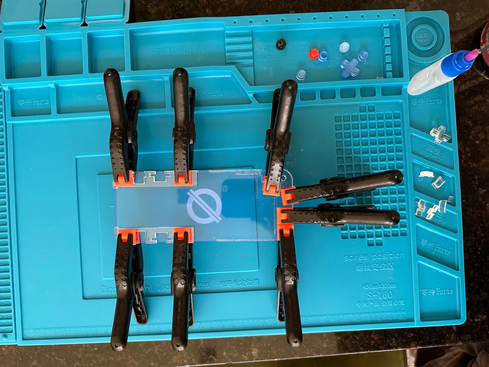 The glued back panel and button holders of the acrylic case