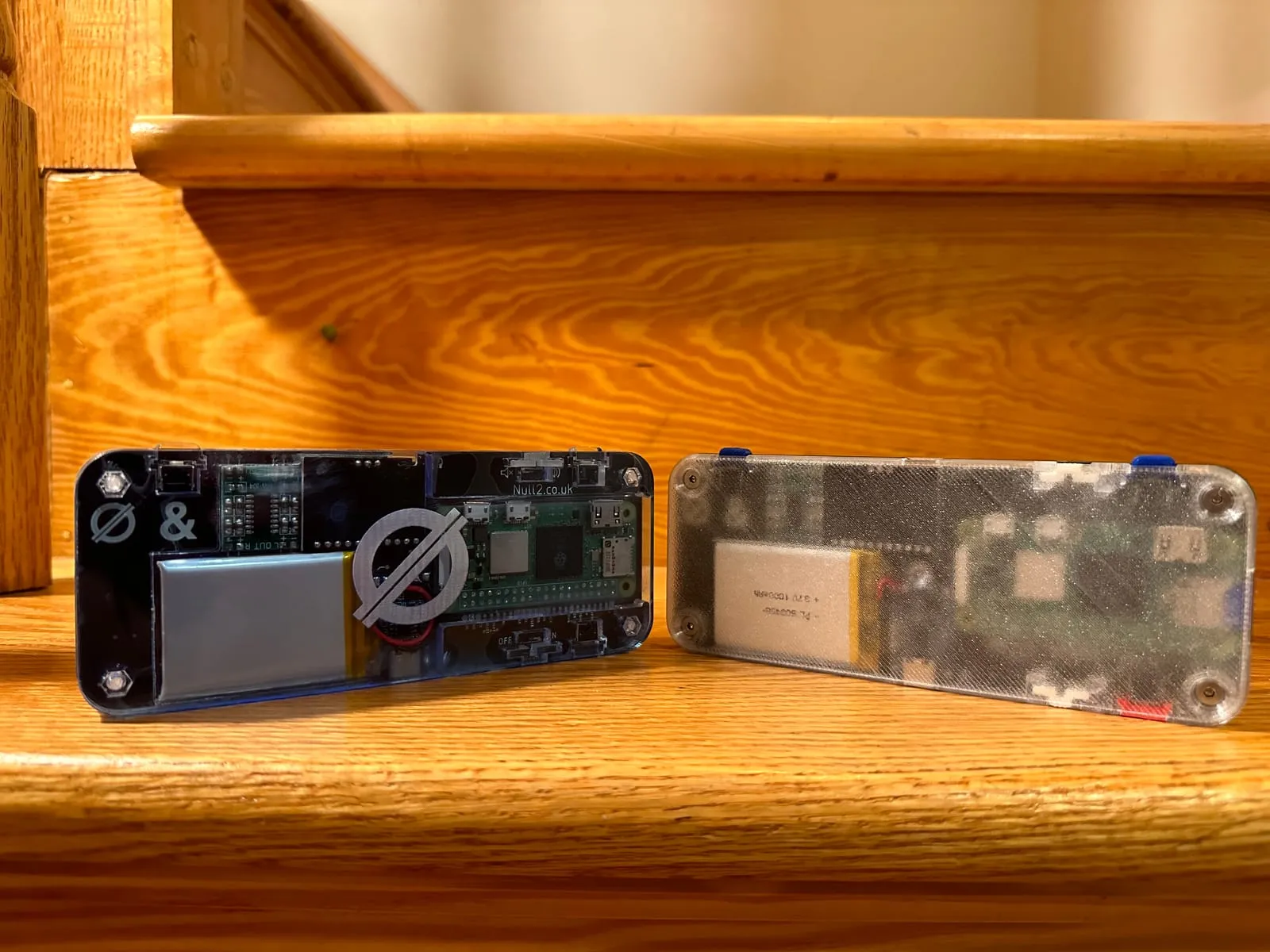The finished Null 2 handheld in its acrylic case, back view